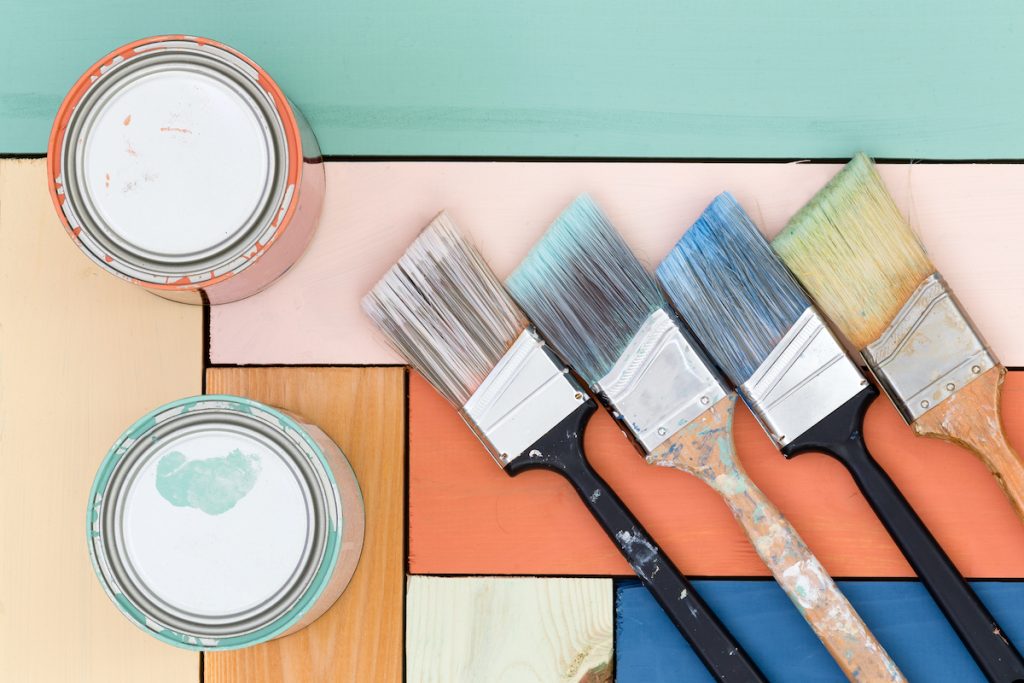 Brushes and pastel-coloured paint tins from the original painting archive